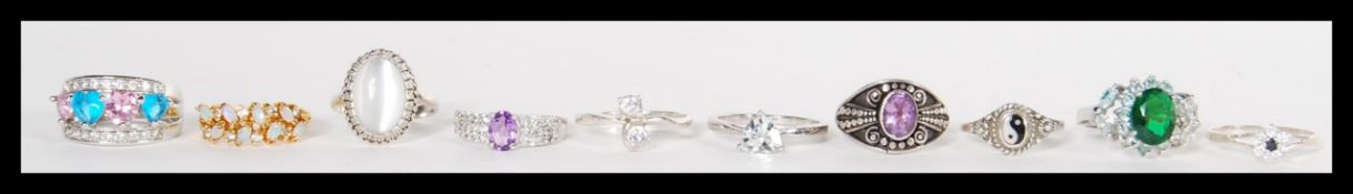 A group of ten sterling silver rings to include opal example, white and blue stone cluster ring,