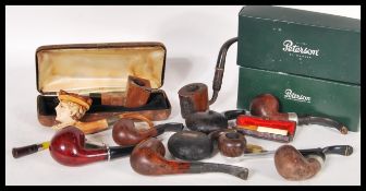 A good collection of vintage smoking tobacco pipes to include two boxed Peterson pipes, cased