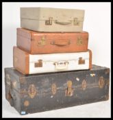A vintage 20th Century heavy duty wardrobe trunk with partially fitted interior and black painted