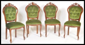 A set of four 20th Century Italian walnut rococo dining chairs, button back backrests with over