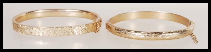Two vintage hallmarked 9ct gold bangle bracelets one having rounded edges with hidden clasp and