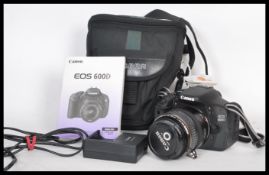 A Canon EOS 600D digital camera in working order, with carry case, charger, power lead, spare