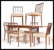 A vintage retro 20th Century teak Danish influence dining table suite with a set of six vintage teak