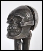 A pair of early 20th Century novelty nut crackers in the form of a skull and bones Rd 740410. The