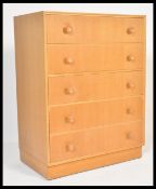 A vintage retro 20th Century Danish influence chest of drawers having a bank of five drawers with