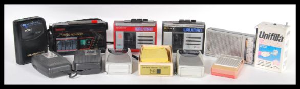 A collection of vintage retro 20th Century transistor radios and walkmans to include Sony,