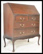 A Queen Anne Revival mahogany bureau being raised on cabriole legs with a series of drawer beneath