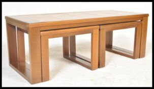 A vintage retro 20th Century teak wood Danish influence coffee nest of table having a larger