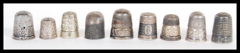 A group of five hallmarked silver thimbles along with silver plated thimbles. Includes Charles