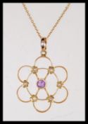 A 19th Century Victorian marked 15ct gold open work pendant in the form of a flower set with seed