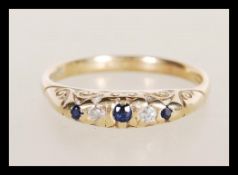 A hallmarked 9ct gold diamond and sapphire ring having flush set blue and white stones. Weighs 2.6