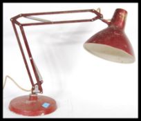 A vintage retro 20th Century 1001 Lamps anglepoise lamp raised on a circular base with conical