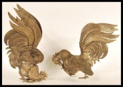 A pair of early 20th Century silver plated figurines depicting fighting cocks or cockerels. Both