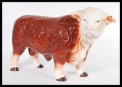 A vintage 20th Century ceramic butchers display figure in the form of a hereford bull, being hand