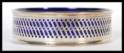 A silver hallmarked Bristol blue glass lined dish, the fret pierced surround with makers marks for