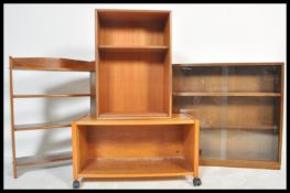 A collection of three retro 20th Century teak wood bookcases, to include a glazed example fitted