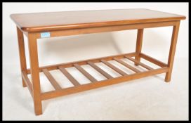 A 20th Century Danish influence retro teak wood coffee table / side table of rectangular form,