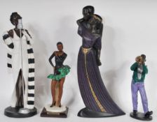 A collection of tall Art Deco style composite figurines to include an embracing couple, a jazz