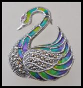 A stamped 925 silver plique a jour brooch in the form of a swan set with marcasites and a red