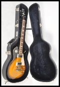 A vintage Aria made Gibson style six string electric guitar having a two tone tobacco sunburst body,