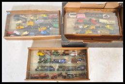 LLEDO AND DAYS GONE DIECAST MODELS IN DISPLAY CABINETS.