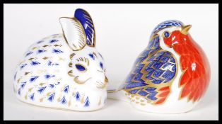 Two Crown Derby china paper weights to include an Imari paperweight in the form of a robin with a