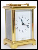 An early 20th Century French gilt brass cased carriage clock by Duverdrey Bloquel. The white