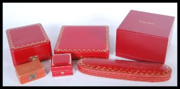 A collection of six red Cartier jewellery boxes to include two necklace boxes with gilt garland