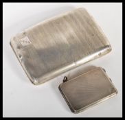 An early 20th Century hallmarked silver Art Deco cigarette case and matching vesta match case