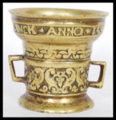 A 16th century style bronze alloy apothecary mortar in the Dutch manner cast to the rim with the