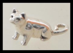 A stamped 925 silver figurine in the form of a cat with a curled tail. Weight 5.8g. Measures