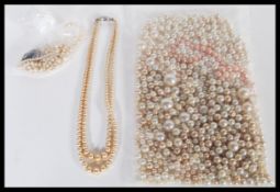 A collection of various vintage 20th Century pearl beads and necklaces to include a bozed lorus