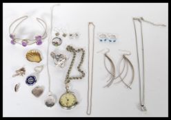 A collection of sterling silver jewellery to include amethyst bangle bracelet, watch, horse