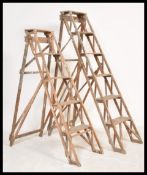 Two good early 20th century Industrial wooden trestle ladder. Each with A-frame design having