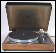 A Linn Sondek LP12 Transcription turntable, the teak cased surround having a smoked perspex hinged