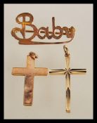 A hallmarked 9ct gold crucifix pendant along with another stamped 9ct gold crucifix pendant and a