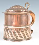 A 19TH CENTURY COPPER LIDDED MUG OR TANKARD HAVING REPOUSSE DECORATION.
