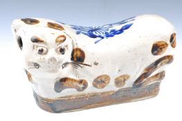 A 19TH CENTURY CHINESE CAT PILLOW HEADREST.