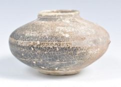 AN ANTIQUE CHINESE POTTERY VASE OF SQUAT FORM.