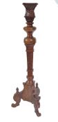 A LARGE MAHOGANY TALL PLANT STAND HAVING FISH GILL CARVINGS