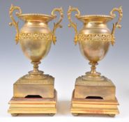 PAIR OF 19TH CENTURY FRENCH BRONZE VASES RAISED ON GILTWOOD STANDS.