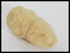 AN EGYPTIAN CARVED LIMESTONE AMANA HEAD