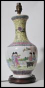 A 20h Century Chinese vase table lamp raised on socle wooden base having white cartouche body
