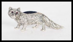 A stamped 925 silver pincushion in the form of a fox having a blue cloth cushion to its back and