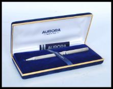 A stamped 925 silver ball point pen by Aurora, set inside a blue velvet lined box. Weight 20.6g.