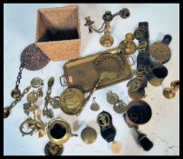 A collection of brass wares to include teapot, bellows, candlesticks, horse brasses etc.