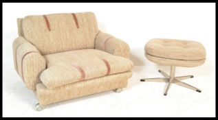 A retro 20th Century oversized armchair together with a matching footstool, each upholstered in a
