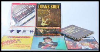 A collection of vinyl long play LP records to include to The Beatles Help and 1962-1966, Duane Eddy,