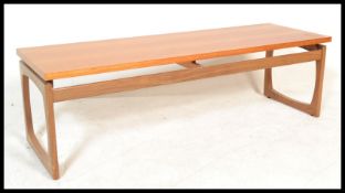 A retro 20th Century teak wood coffee table of rectangular form raised on quadrille style