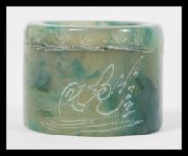 A Chinese green jade archer ring of typical form being signed to side.